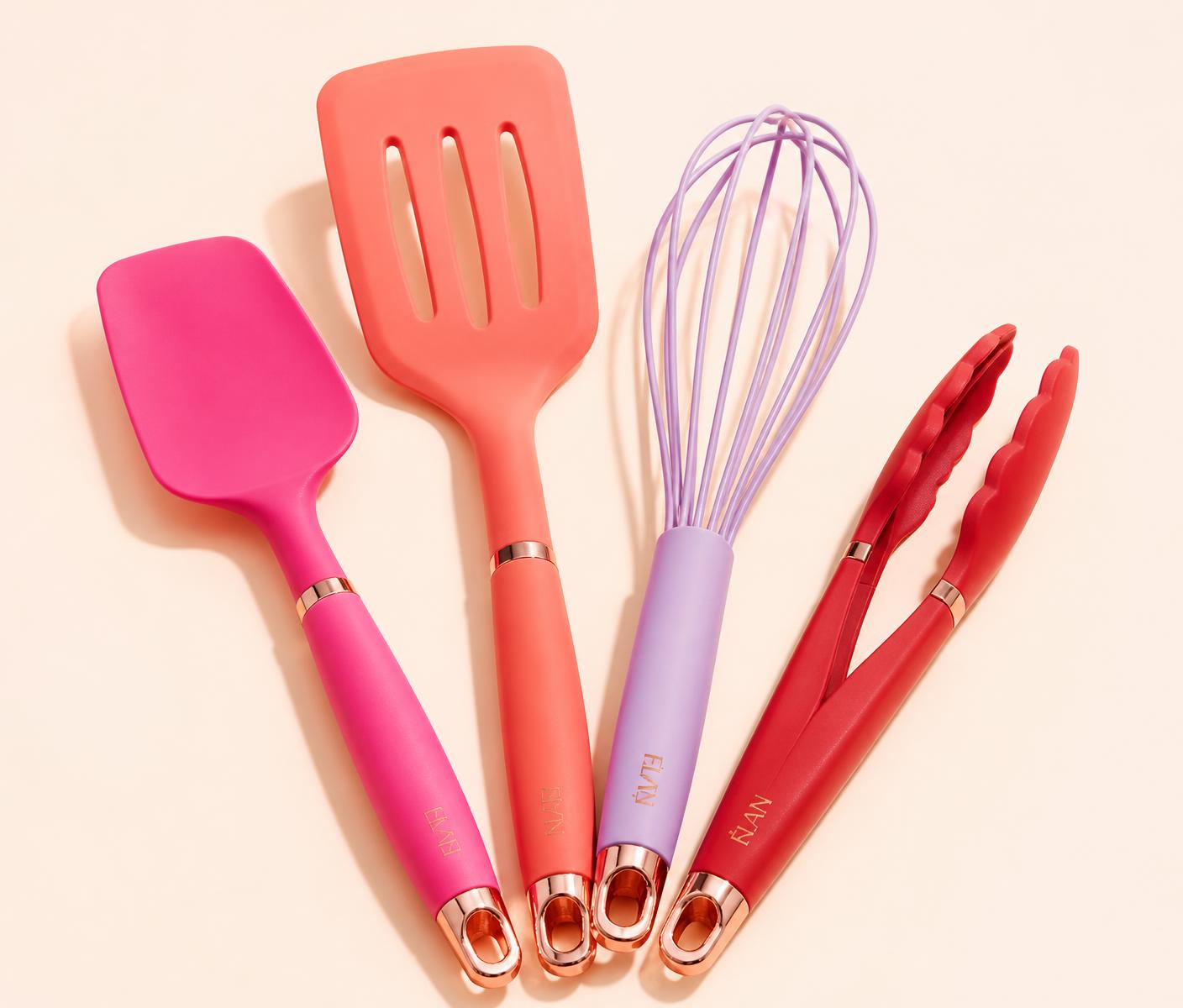 Hot pink, coral, lilac and cherry red kitchen utensils on a cream background